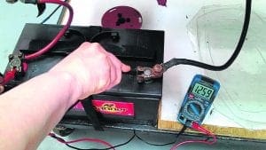 Place the black probe on the – (negative) terminal. PHOTOS: RCR
