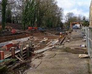 contractors working on drained canal