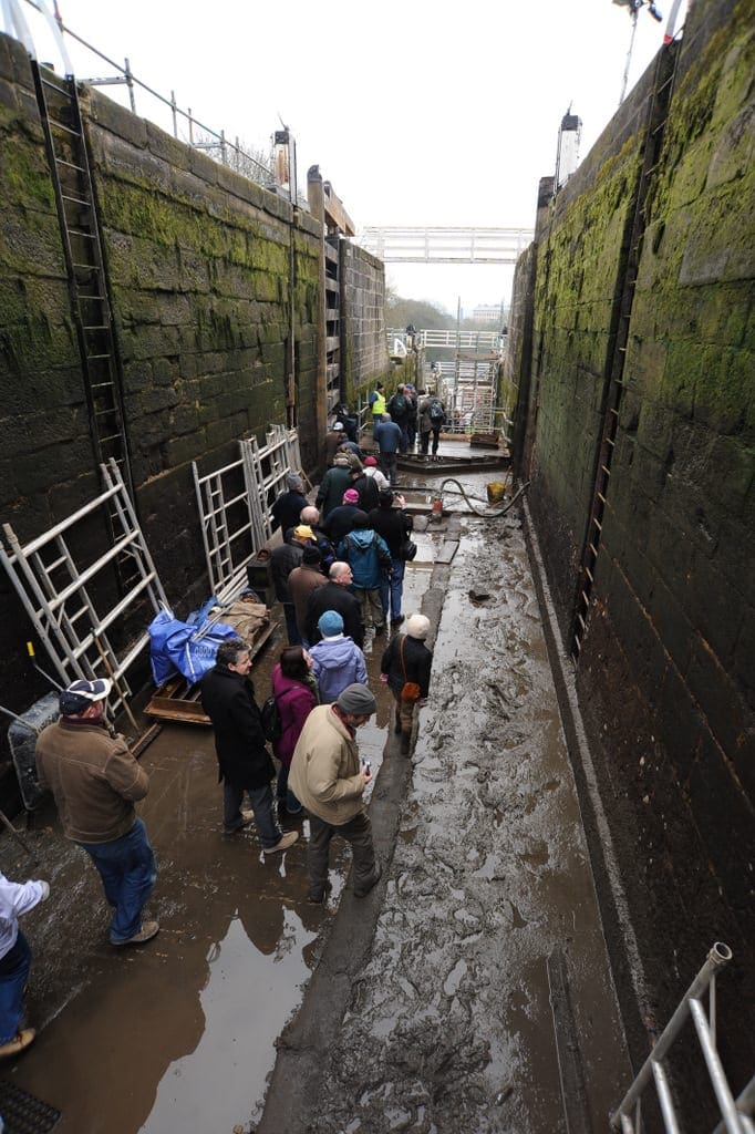 people in the bottom of drained lock