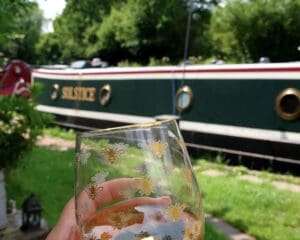 Enjoying a drink in the sun next to narrowboat Solstice