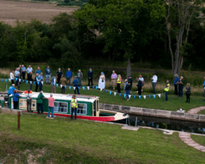 Grantham Canal Society’s Three Shires trip boat is the first through Lock 14 in 90 years.