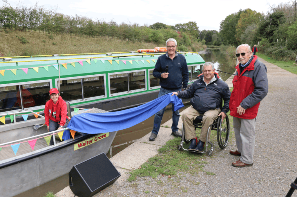 Unveiling the Walter Grove are, from left: Wey & Arun Canal Trust skipper Louise Osborne, boat director John Reynolds, Wheelyboat Trust director Andy Beadsley and Ian Hair, cousin of benefactor Peter Grove. PHOTO: JULIAN MORGAN