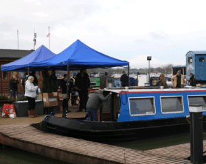 The vaccination ‘booster boat’ and the gazebos at the Caen Hill Marina wharf.