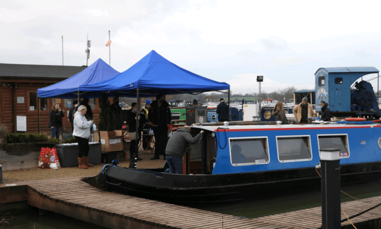The vaccination ‘booster boat’ and the gazebos at the Caen Hill Marina wharf.
