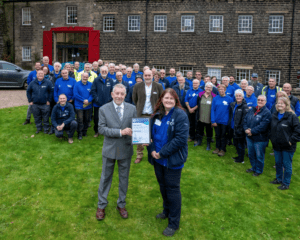 David Booker of the Marsh Charitable Trust presents Cath Munn with her award watched by Canal & River Trust volunteer nominees and staff.