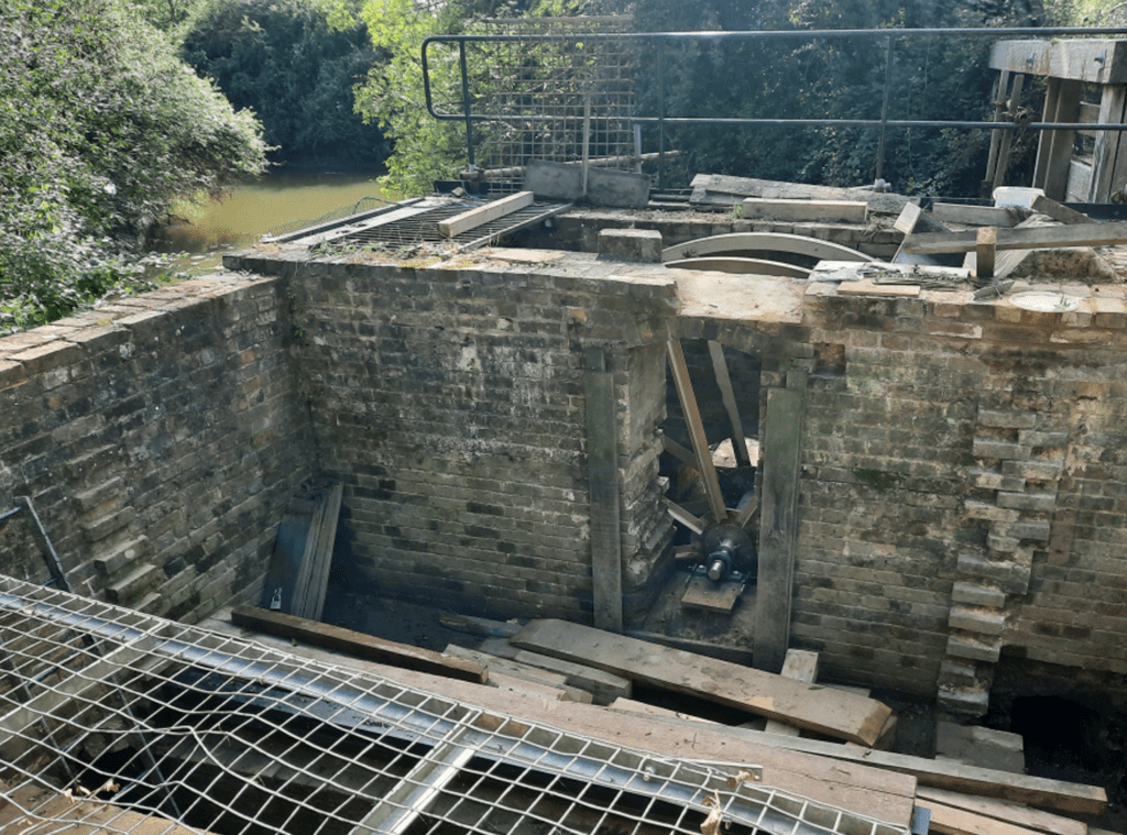 The waterwheel being restored.