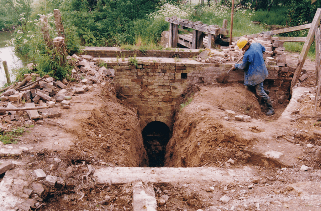 Winston Harwood hard at work near the site of the waterwheel in the original restoration.