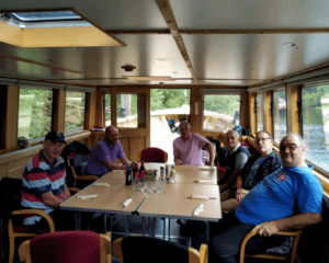 John Joyce, right, with veterans on the River Thames.