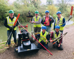 Dave Maloney, second from left and fellow volunteers in front of the restored canal at Pewsham, with some of the new equipment funded by Chippenham Borough Lands Charity. PHOTO: JUSTIN GUY