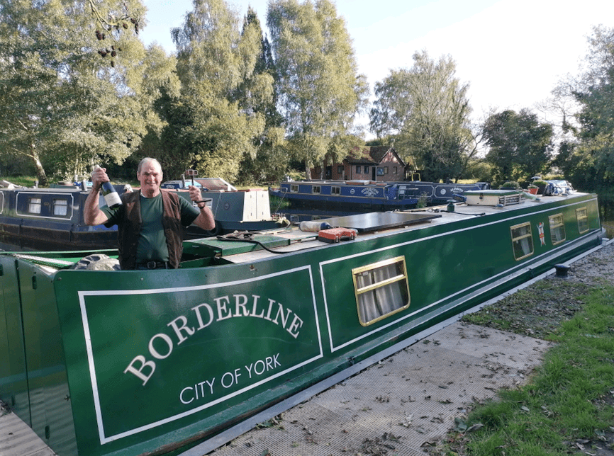 Back at his home base at Melbourne Basin on the Pocklington Canal – Jon Reynolds on board Borderline with his celebratory bottle of bubbly.
