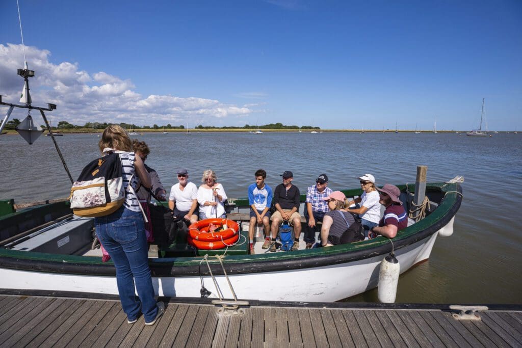 Visitors reaching the 'Island' by the National Trust ferry at Orford Ness National Nature Reserve, Suffolk