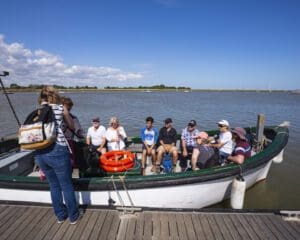 Visitors reaching the 'Island' by the National Trust ferry at Orford Ness National Nature Reserve, Suffolk