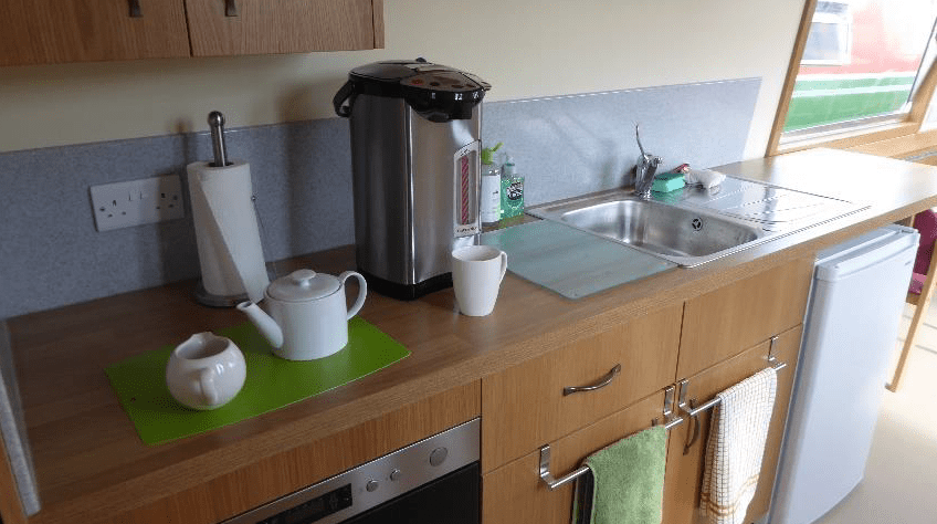 Galley kitchen with hot water for drinks and a fridge to keep picnics cool.