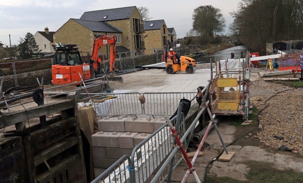 The final levelling and compacting of the stone in the lock chamber ready for piling work.