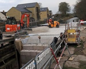 The final levelling and compacting of the stone in the lock chamber ready for piling work.