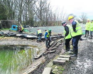 Volunteers removing blocks and liner.
