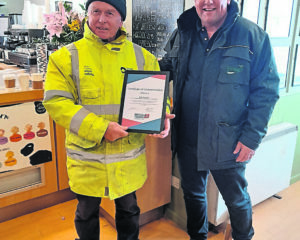 Retiring lock keeper Bob Preston receiving a British Marine certificate of commendation from Russell Fletcher at Foxhangers.