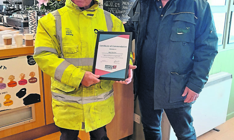 Retiring lock keeper Bob Preston receiving a British Marine certificate of commendation from Russell Fletcher at Foxhangers.