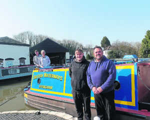 Father and son narrowboat painters Dave and Aaron Bishop with proud owners Keith and Jill Astley astern on the repainted Effingham at Braunston Marina. PHOTO: TIM COGHLAN
