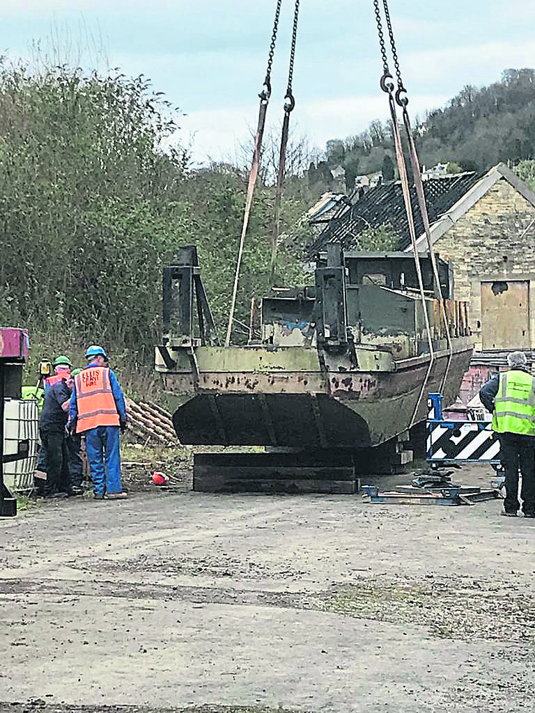 The barge is craned off awaiting restoration work.