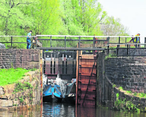 The first two narrowboats down the flight, Bee Happy and Moles about to leave Lock 73.