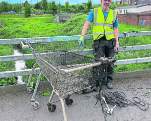 Tim Rane with trolleys 50 and 51 retrieved from the River Foss in York.