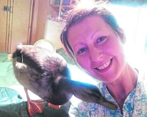 Lena Rodriguez and her feathered friend Howie.