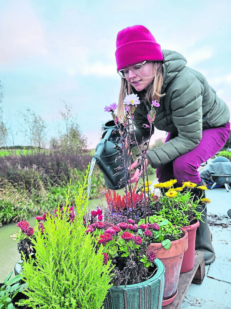 May watering her roof-top plants.