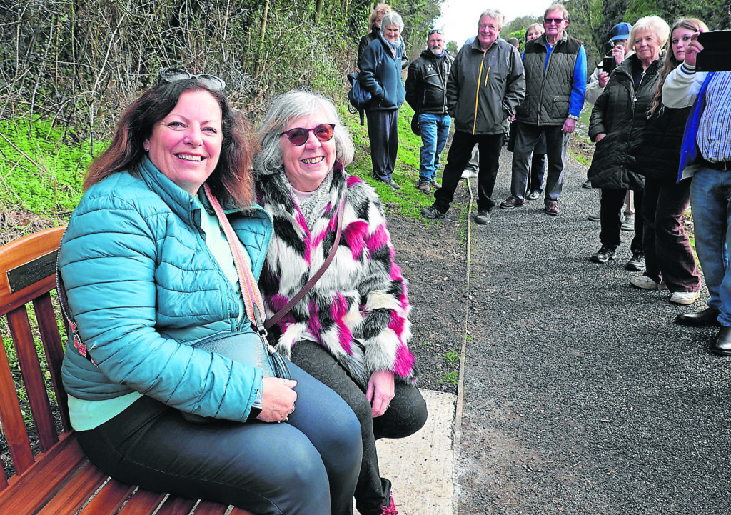 Smiling through: Sarah Borondy, daughter of David Blagrove, and Chrissy Sears on Roy Sears’ newly opened canal-bank seat. 