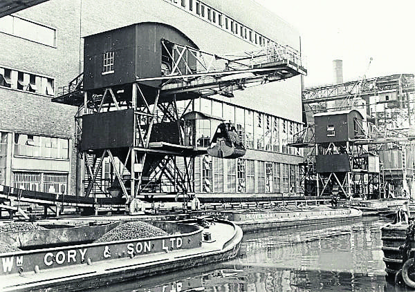 This photograph taken between 1950 and 1969 shows barges unloading at Hackney Power Station, near Millfields Park in Clapton, now the site of a recycling centre.
