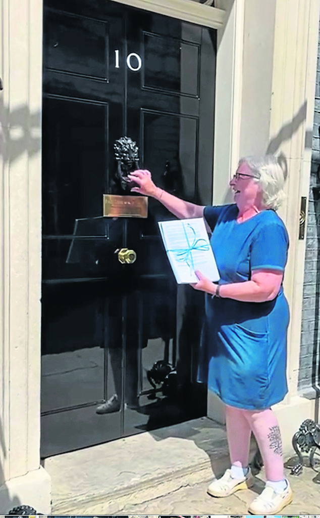 Kim knocks on the door of No 10 Downing Street to hand in the petition. PHOTOS SUPPLIED BY KIM MARSHALL AND ANITA WEEDY UNLESS INDICATED