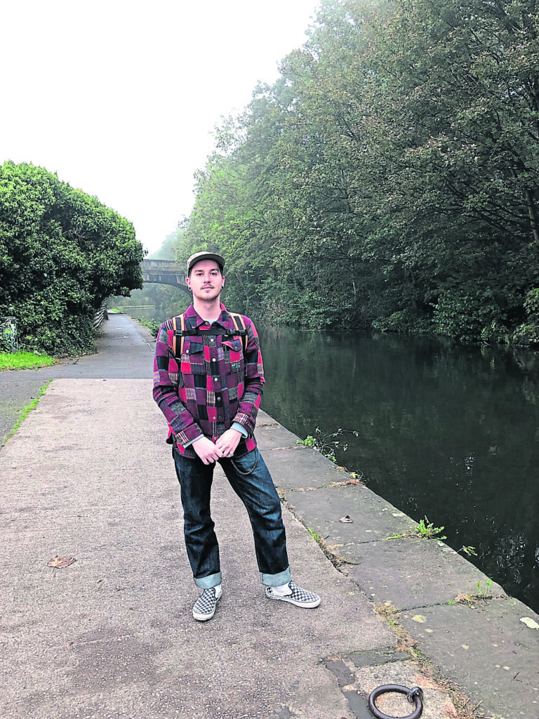 Artist Jaydon Rowbottom, whose family have a strong canal heritage, by the Leeds & Liverpool canal.