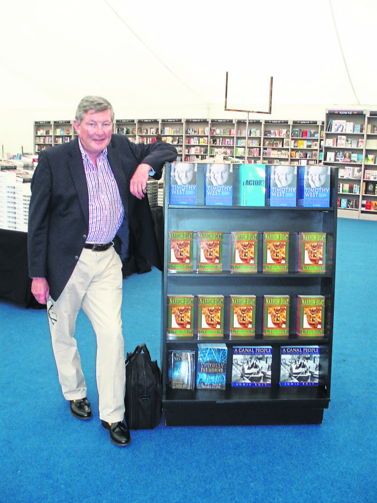 Tim Coghlan in the Waterstone marquee at the Cheltenham Lit Fest, with its canal-themed book stand to support the two Tims’ presentation. The books included a new edition of Tom Rolt’s Narrow Boat, Sonia Rolt’s A Canal People and Timothy West’s autobiography, A Moment Towards the End of the Play… PHOTO: TIM COGHLAN COLLECTION