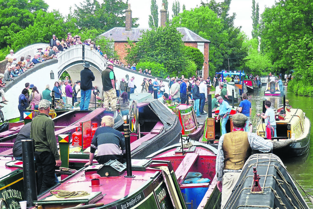 The organised chaos of the 2013 Braunston Historic Narrowboat Rally as seen from the front of President. Timothy West was steering the boat under close supervision from chairman Nick Haines. PHOTO: TIM COGHLAN