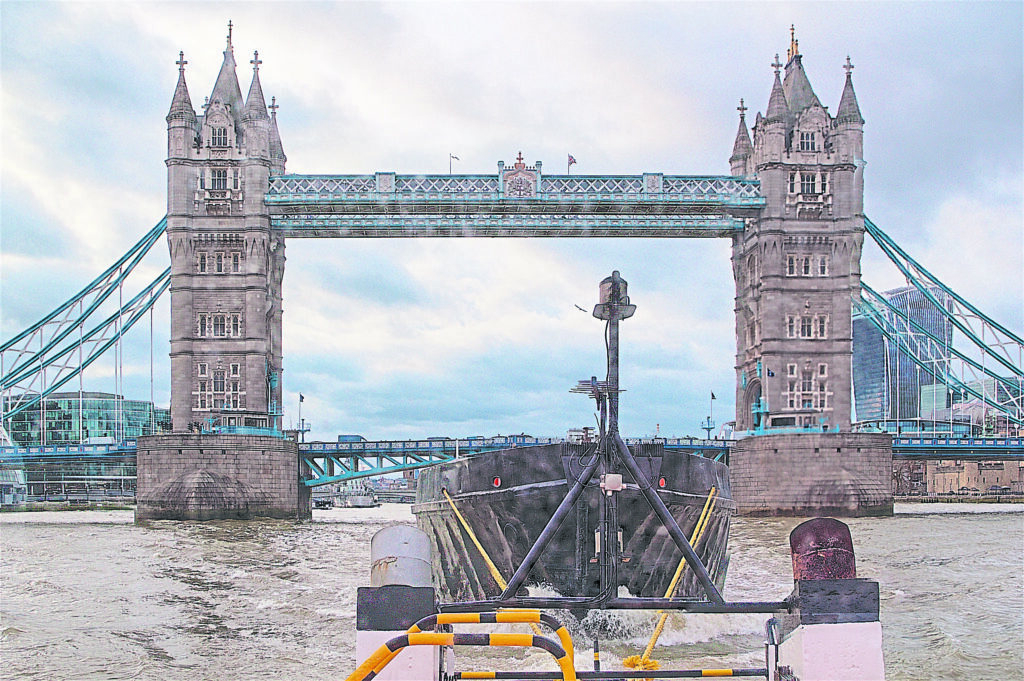 The barge and tug combination is a common form of low carbon transport through the centre of London.
