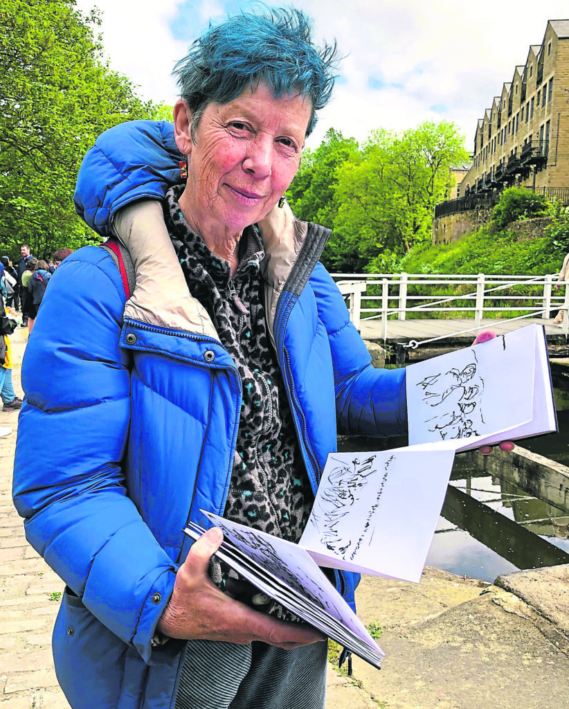 Artist Lou Sumray, with her sketch book documenting The Bradford Progress, at Three Rise Locks, Bingley. PHOTO: SALLY CLIFFORD