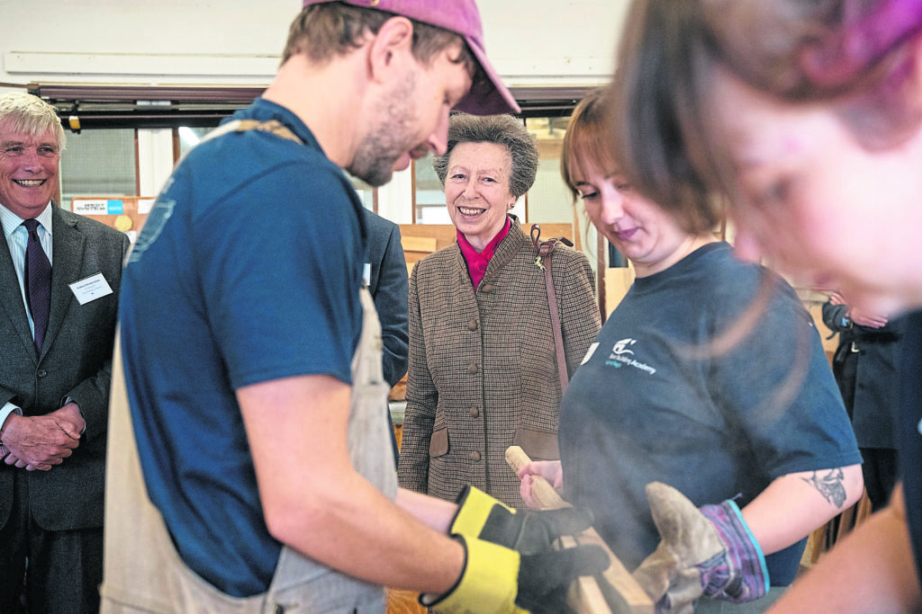 Princess Anne and the Lord-Lieutenant of Dorset, Prof Michael Dooley, watch the steam bending demonstration.
