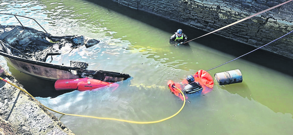 Preparing to lift the boat out of the water.