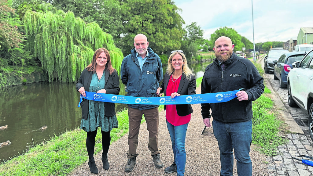 Cutting the ribbon are, left to right, Heather Pritchard (TRU), Sean McGinley (Canal & River Trust), Kim Leadbeater (MP for Spen Valley) and Mark Ferris (Kirklees Council). PHOTO: Network Rail.
